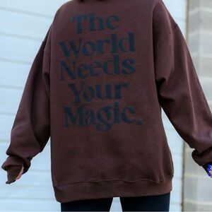 Dressed in LALA the world needs your magic brown and black crewneck